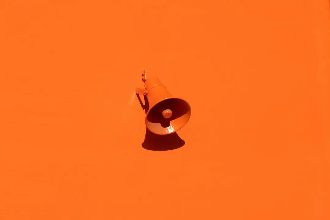 orange megaphone on orange wall